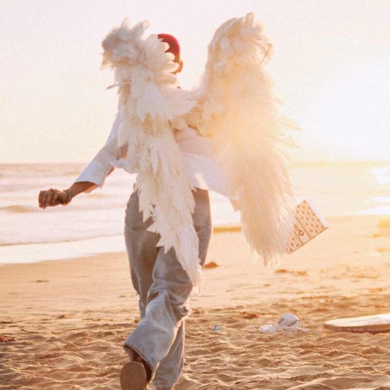 A girl with angels wings are walking on the beach and thinking about how to recover from weed