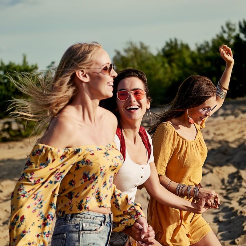 girls running on the beach and laughing