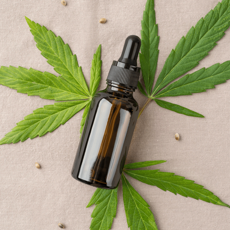 on the table is a brown glass jar with a cannabis leaf