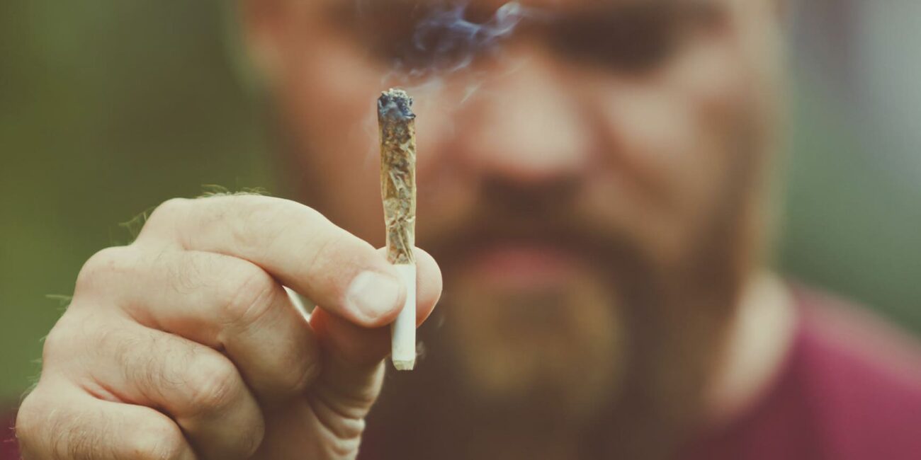 a person holding a joint