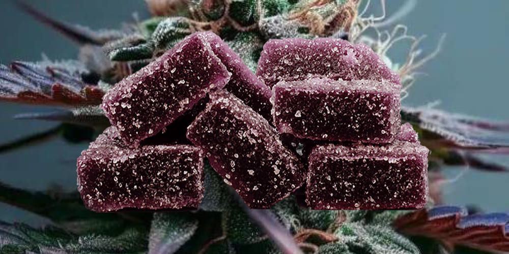 A set of vibrant blackberry THC gummies on a wooden plate