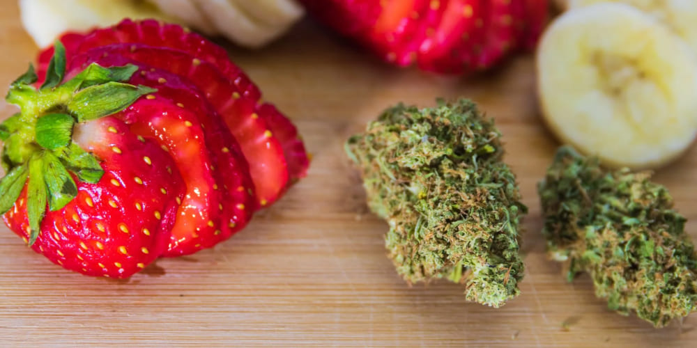 Pineapple Express cannabis buds with sliced pineapple and citrus fruits.