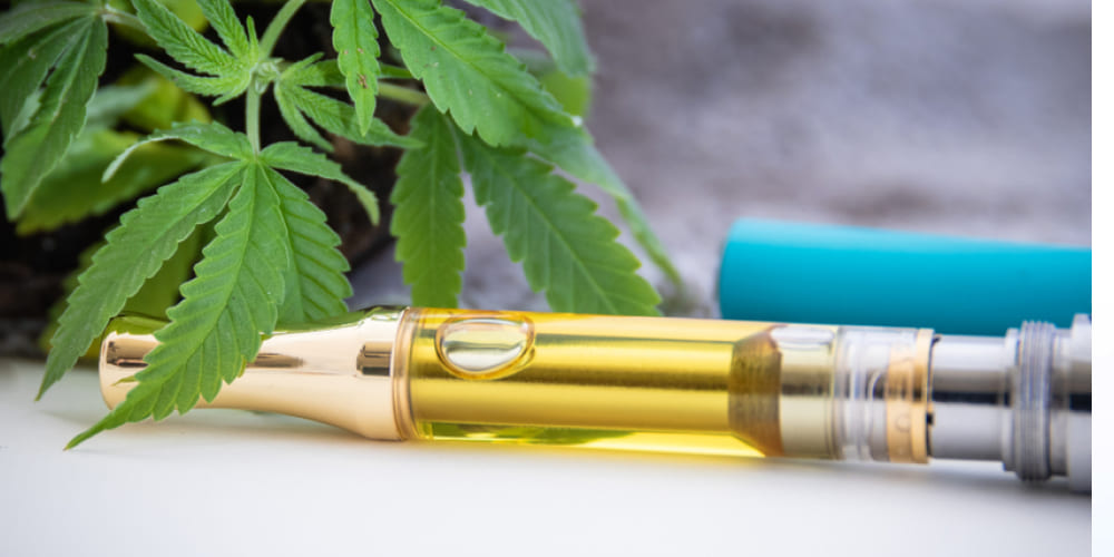 A rosin vape cartridge containing golden, solvent-free cannabis extract.