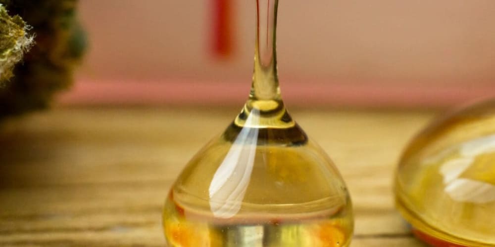 What Is Distillate Weed? Cannabis vape cartridge filled with clear distillate oil