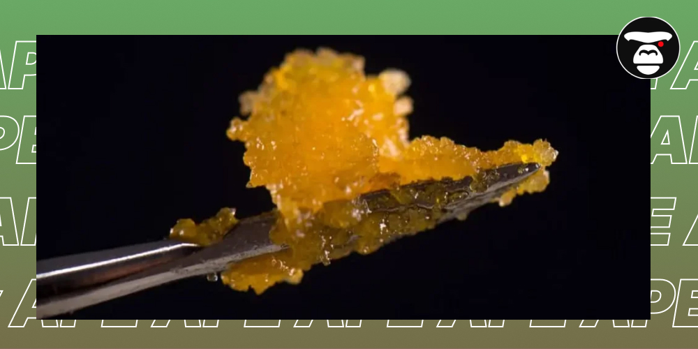 Three glasses of green, iced cocktails garnished with lime slices and cannabis leaves.