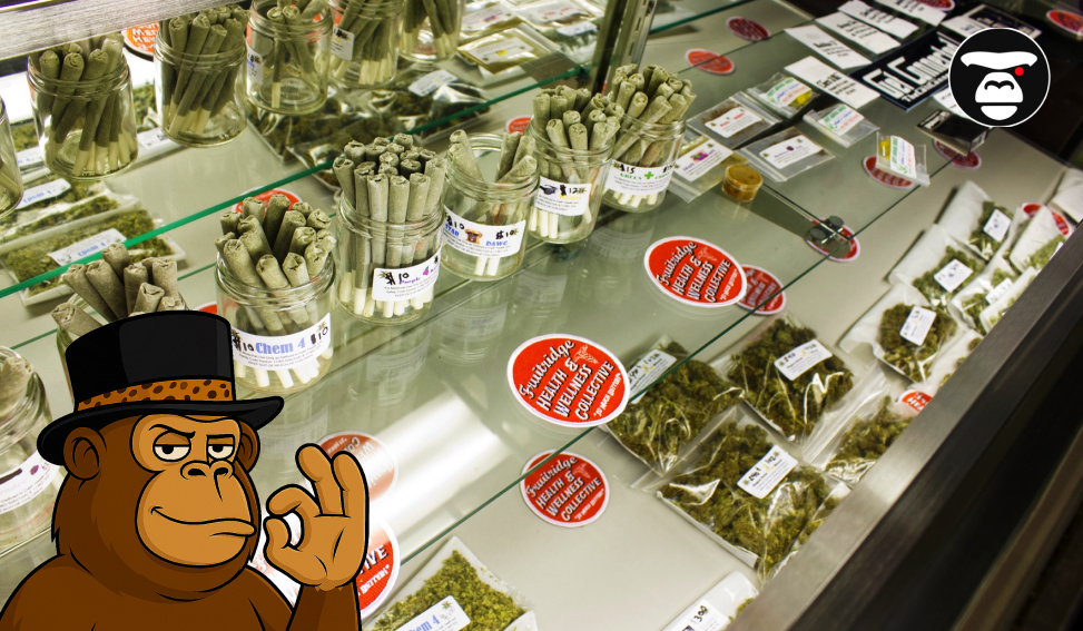 A retail display case filled with jars of cannabis pre-rolls, packaged flower, and branded stickers in a dispensary.