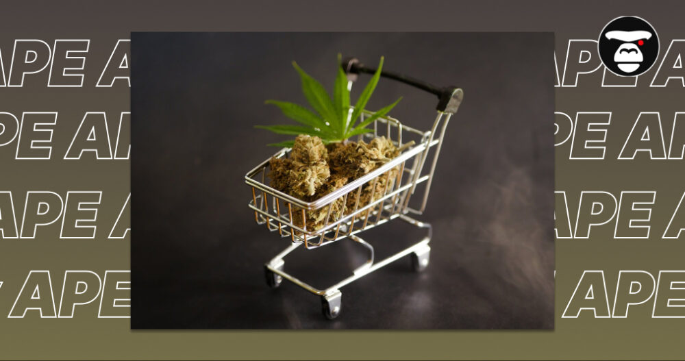 Miniature shopping cart filled with dried cannabis flower buds and a green leaf.