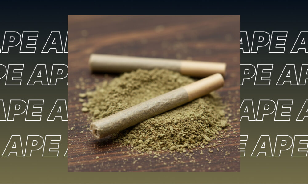 Two pre-rolled joints resting on a pile of ground cannabis flower.